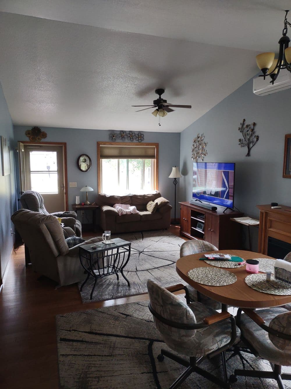 Cozy living room featuring a TV, comfortable seating, and a stylish rug.