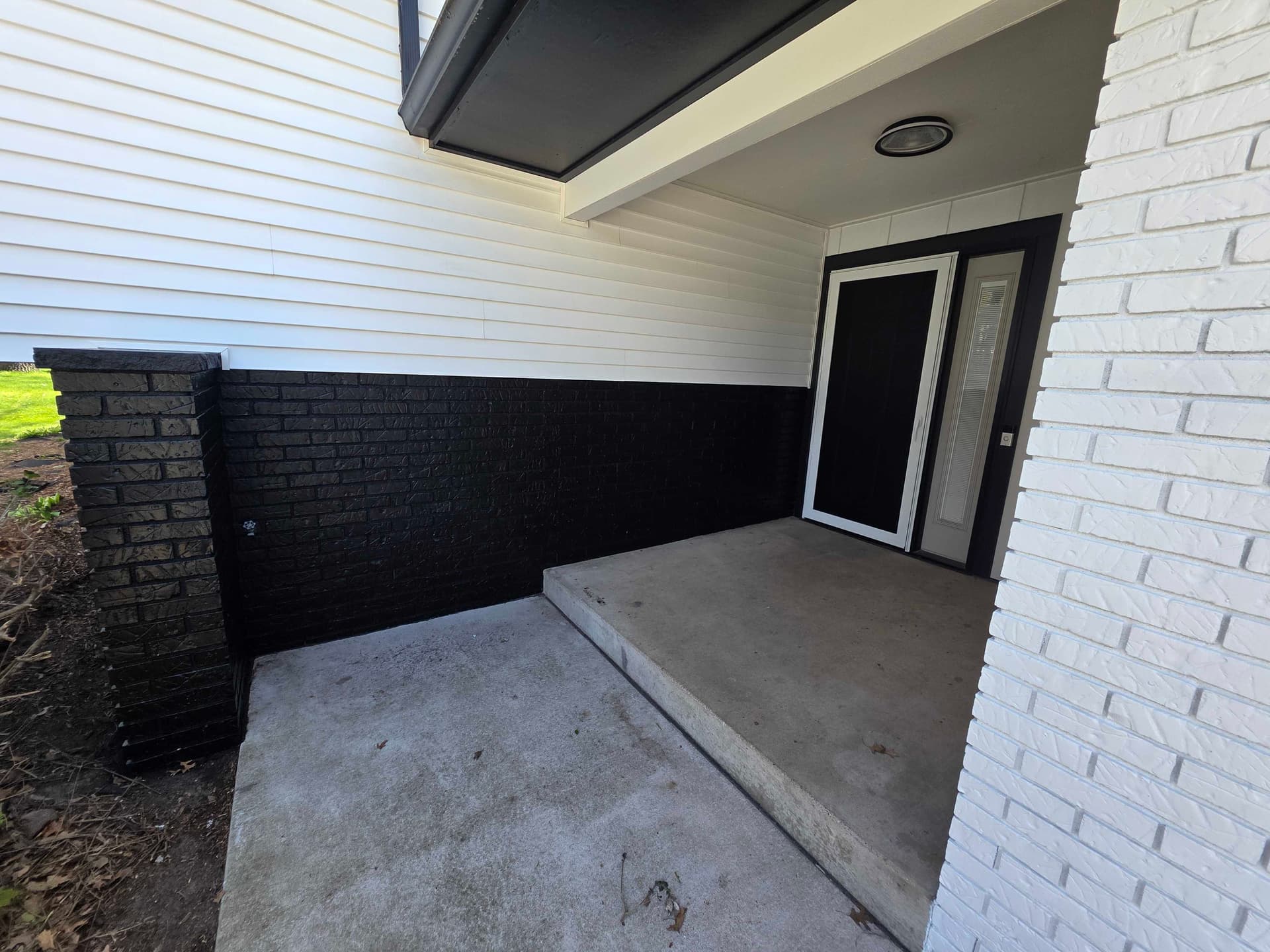 Gallery photos for Bold Black and White Exterior Repaint on Wisconsin Brick-and-Siding Home: Image #3