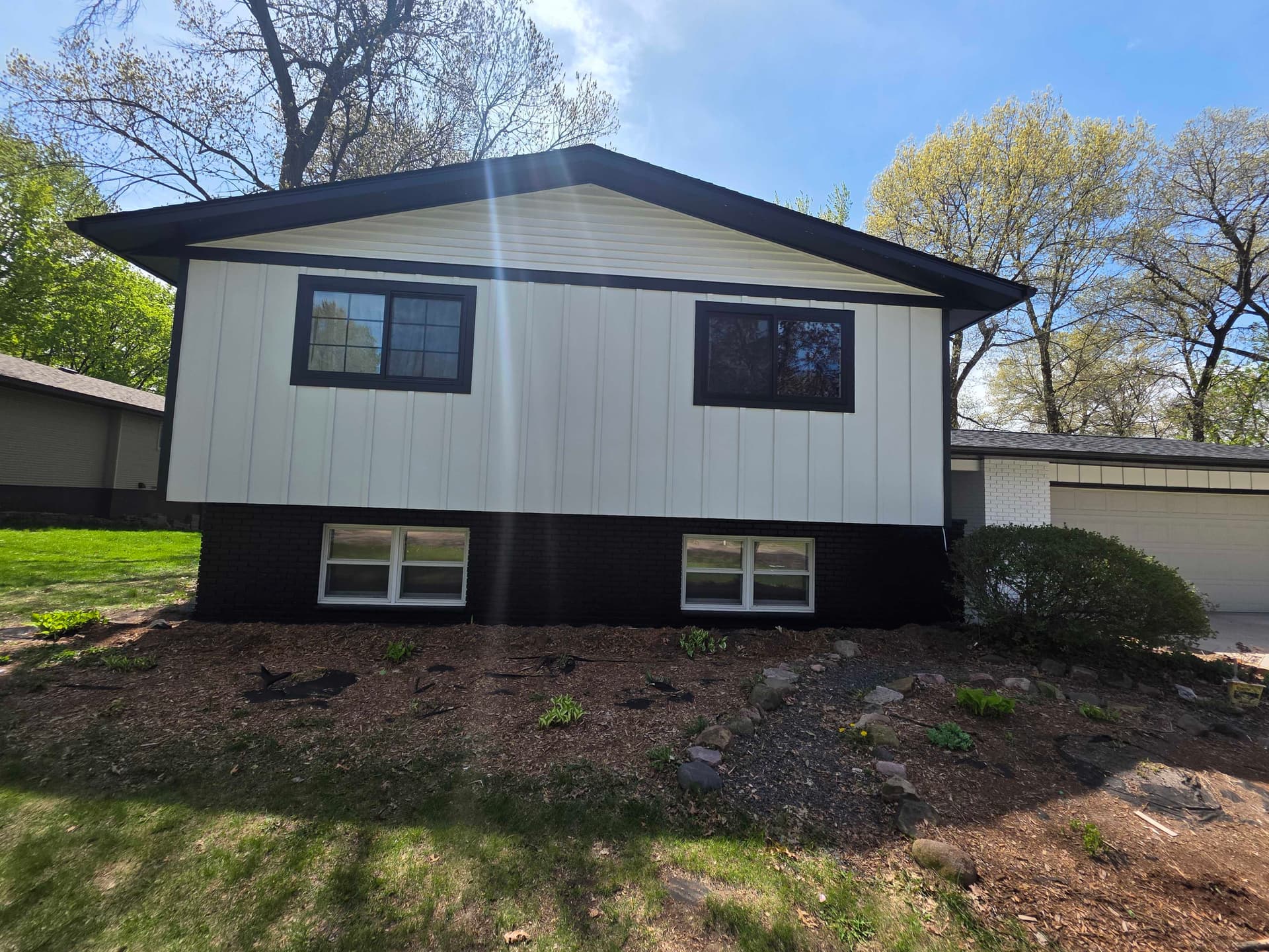 Gallery photos for Bold Black and White Exterior Repaint on Wisconsin Brick-and-Siding Home: Image #1