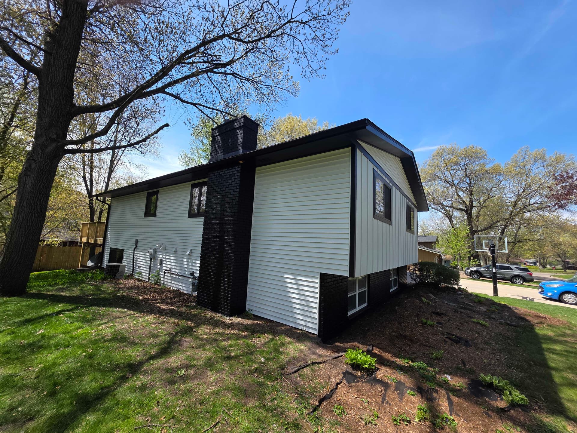 Bold Black and White Exterior Repaint on Wisconsin Brick-and-Siding Home image